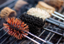 best bbq grill brush - photo of several types of cleaning brushes on a cold grill