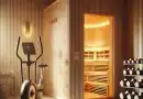 combining infrared sauna and exercise by showing an infrared sauna next to an exercise bike and a rack of weights